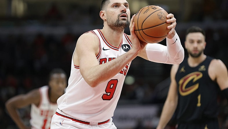 Dec 23, 2023; Chicago, Illinois, USA; Chicago Bulls center Nikola Vucevic (9) shoots a free throw against the Cleveland Cavaliers during the first half at United Center. Mandatory Credit: Kamil Krzaczynski-USA TODAY Sports
