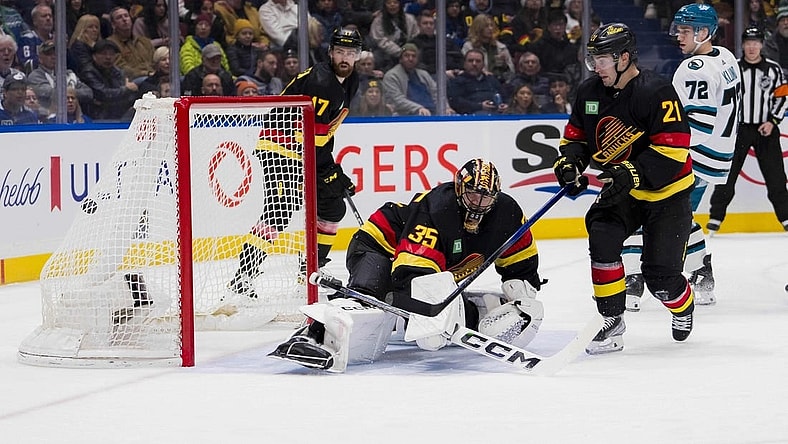 Dec 23, 2023; Vancouver, British Columbia, CAN; San Jose Sharks forward William Eklund (72) and Vancouver Canucks forward Nils Hoglander (21) watch the shot from forward Fabian Zetterlund (20) beat goalie Thatcher Demko (35) in the second period at Rogers Arena. Mandatory Credit: Bob Frid-USA TODAY Sports