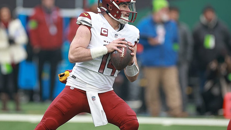 Dec 24, 2023; East Rutherford, New Jersey, USA; Washington Commanders quarterback Sam Howell (14) drops back to pass during the first quarter against the New York Jets at MetLife Stadium. Mandatory Credit: Vincent Carchietta-USA TODAY Sports