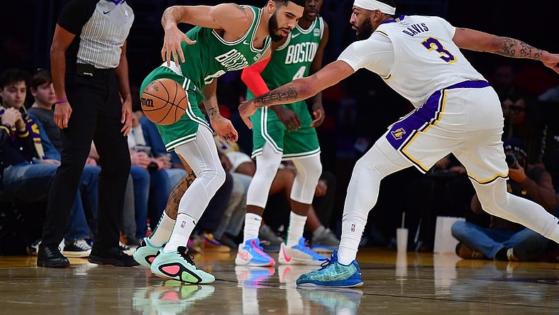 Dec 25, 2023; Los Angeles, California, USA; Boston Celtics forward Jayson Tatum (0) loses the ball against Los Angeles Lakers forward Anthony Davis (3) during the first half at Crypto.com Arena. Mandatory Credit: Gary A. Vasquez-USA TODAY Sports