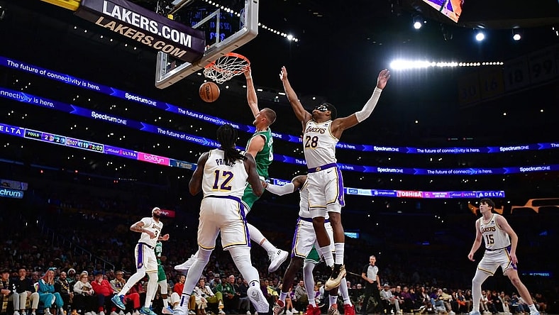 Dec 25, 2023; Los Angeles, California, USA; Boston Celtics center Kristaps Porzingis (8) dunks for the basket against Los Angeles Lakers forward Rui Hachimura (28) and forward Taurean Prince (12) during the second half at Crypto.com Arena. Mandatory Credit: Gary A. Vasquez-USA TODAY Sports