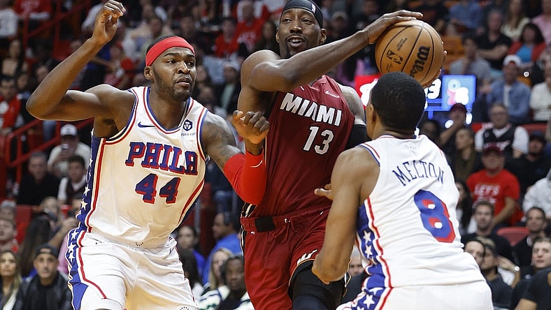 Dec 25, 2023; Miami, Florida, USA; Philadelphia 76ers forward Paul Reed (44) and  guard De'Anthony Melton (8) defend Miami Heat center Bam Adebayo (13) during the first half at Kaseya Center. Mandatory Credit: Rhona Wise-USA TODAY Sports