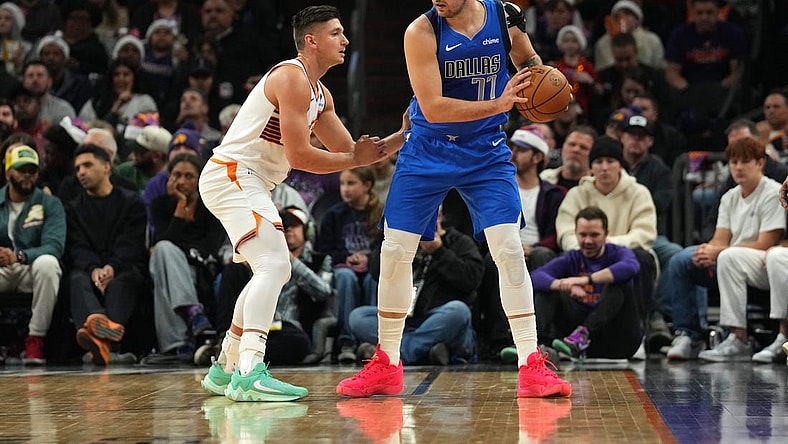 Dec 25, 2023; Phoenix, Arizona, USA; Phoenix Suns guard Grayson Allen (8) guards Dallas Mavericks guard Luka Doncic (77) during the first half at Footprint Center. Mandatory Credit: Joe Camporeale-USA TODAY Sports
