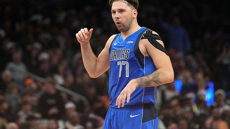 Dec 25, 2023; Phoenix, Arizona, USA; Dallas Mavericks guard Luka Doncic (77) celebrates against the Phoenix Suns after scoring a basket that put him over 10,000 points for his career during the first half of the game at Footprint Center. Mandatory Credit: Joe Camporeale-USA TODAY Sports