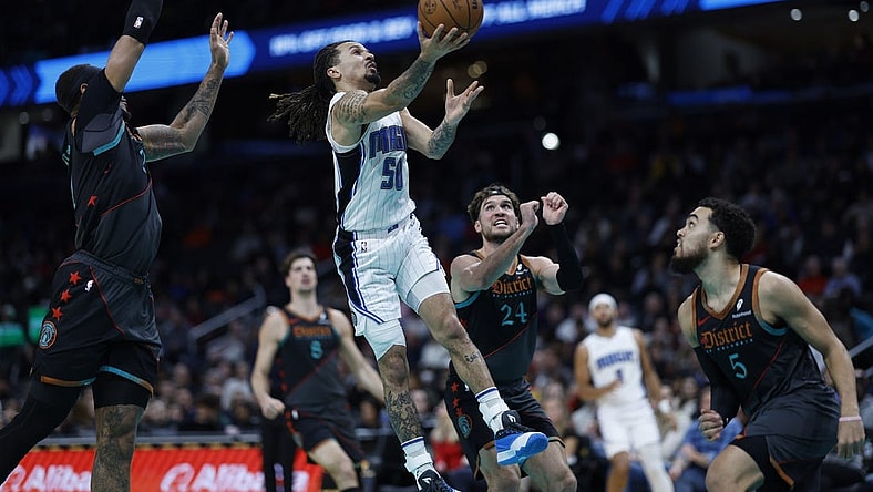 Dec 26, 2023; Washington, District of Columbia, USA; Orlando Magic guard Cole Anthony (50) shoots the ball as Washington Wizards center Daniel Gafford (21) defends in the second quarter at Capital One Arena. Mandatory Credit: Geoff Burke-USA TODAY Sports