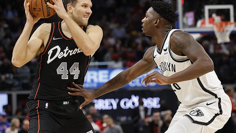 Dec 26, 2023; Detroit, Michigan, USA; Detroit Pistons forward Bojan Bogdanovic (44) is defended by Brooklyn Nets forward Dorian Finney-Smith (28) in the first half at Little Caesars Arena. Mandatory Credit: Rick Osentoski-USA TODAY Sports