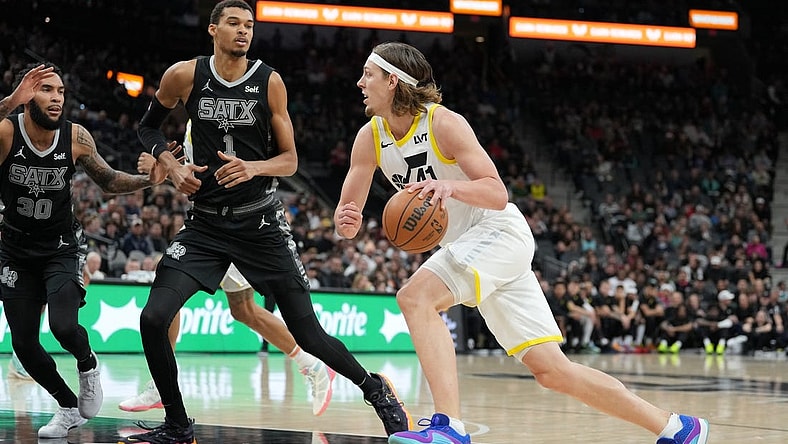 Dec 26, 2023; San Antonio, Texas, USA; Utah Jazz forward Kelly Olynyk (41) drives to the basket against San Antonio Spurs center Victor Wembanyama (1) in the first half at the Frost Bank Center. Mandatory Credit: Daniel Dunn-USA TODAY Sports