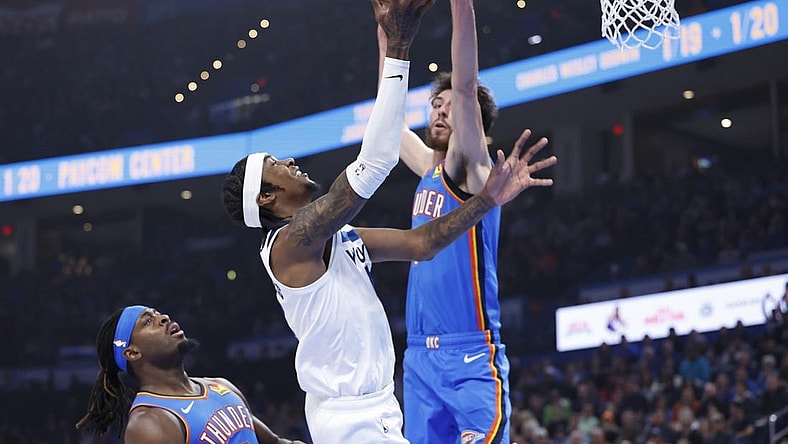 Dec 26, 2023; Oklahoma City, Oklahoma, USA; Minnesota Timberwolves forward Jaden McDaniels (3) is defended by Oklahoma City Thunder forward Chet Holmgren (7) on a shot during the first quarter at Paycom Center. Mandatory Credit: Alonzo Adams-USA TODAY Sports