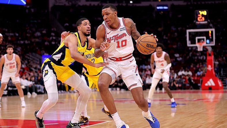 Dec 26, 2023; Houston, Texas, USA; Houston Rockets forward Jabari Smith Jr. (10) handles the ball against Indiana Pacers guard Tyrese Haliburton (0) during the first quarter at Toyota Center. Mandatory Credit: Erik Williams-USA TODAY Sports