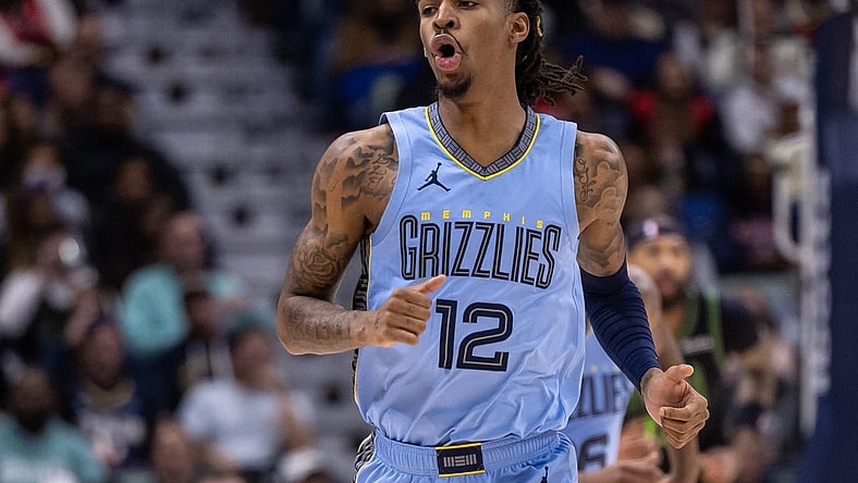 Dec 26, 2023; New Orleans, Louisiana, USA; Memphis Grizzlies guard Ja Morant (12) reacts to a made basket against the New Orleans Pelicans during the first half at Smoothie King Center. Mandatory Credit: Stephen Lew-USA TODAY Sports