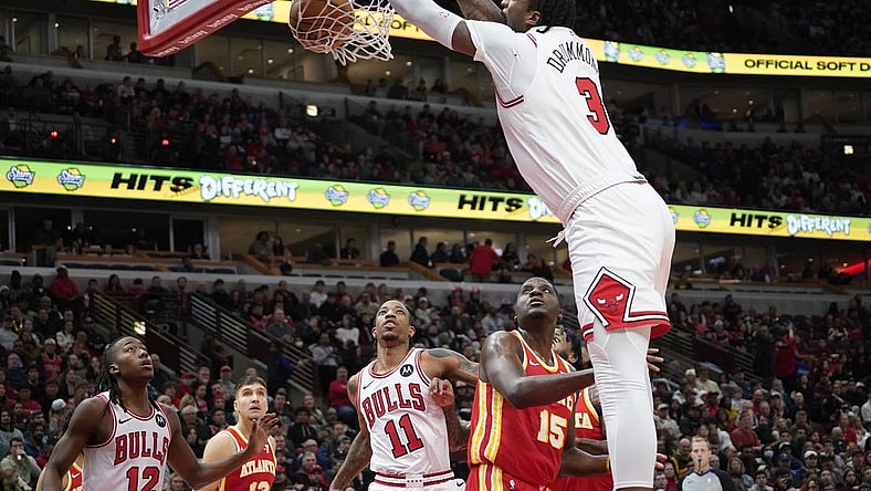 Dec 26, 2023; Chicago, Illinois, USA; Chicago Bulls center Andre Drummond (3) dunks the ball over Atlanta Hawks center Clint Capela (15) during the first quarter at United Center. Mandatory Credit: David Banks-USA TODAY Sports