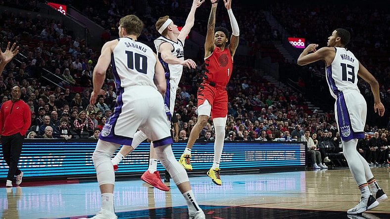 Dec 26, 2023; Portland, Oregon, USA; Portland Trail Blazers guard Anfernee Simons (1) shoots a jump shot against Sacramento Kings guard Kevin Huerter (9) during the first half at Moda Center. Mandatory Credit: Troy Wayrynen-USA TODAY Sports