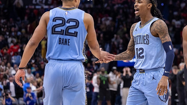 Dec 26, 2023; New Orleans, Louisiana, USA; Memphis Grizzlies guard Ja Morant (12) celebrates going to overtime with guard Desmond Bane (22) against the New Orleans Pelicans during the second half at Smoothie King Center. Mandatory Credit: Stephen Lew-USA TODAY Sports