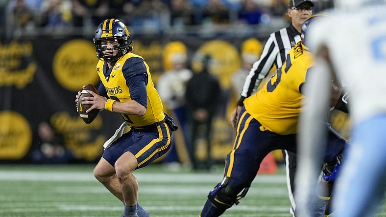 Dec 27, 2023; Charlotte, NC, USA; West Virginia Mountaineers quarterback Garrett Greene (6) in action during the first half at Bank of America Stadium. Mandatory Credit: Jim Dedmon-USA TODAY Sports