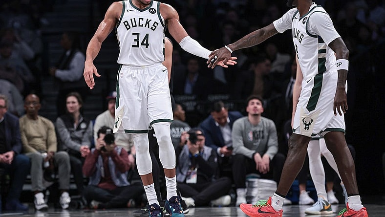Dec 27, 2023; Brooklyn, New York, USA; Milwaukee Bucks forward Giannis Antetokounmpo (34) slaps hands with forward Bobby Portis (9) during the first half against the Brooklyn Nets at Barclays Center. Mandatory Credit: Vincent Carchietta-USA TODAY Sports