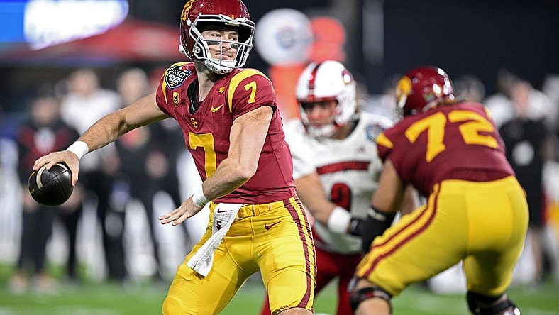 Dec 27, 2023; San Diego, CA, USA; USC Trojans quarterback Miller Moss (7) throws a pass against the Louisville Cardinals during the first half at Petco Park. Mandatory Credit: Orlando Ramirez-USA TODAY Sports