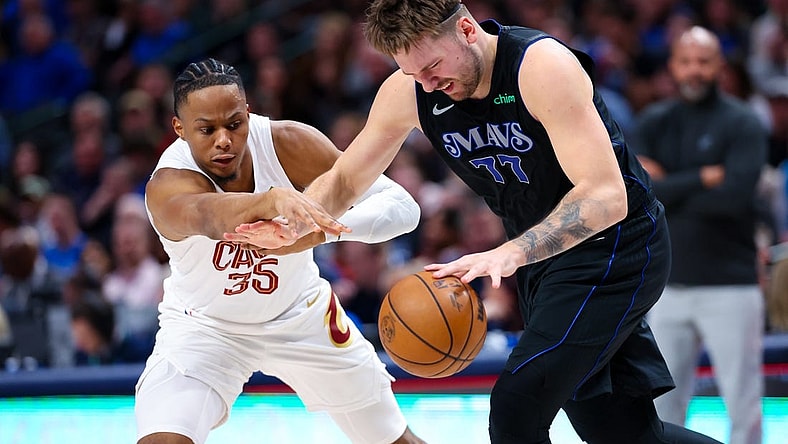 Dec 23, 2023; Dallas, Texas, USA;  Dallas Mavericks guard Luka Doncic (77) looks to controls the ball as Cleveland Cavaliers forward Isaac Okoro (35) defends during the second quarter at American Airlines Center. Mandatory Credit: Kevin Jairaj-USA TODAY Sports