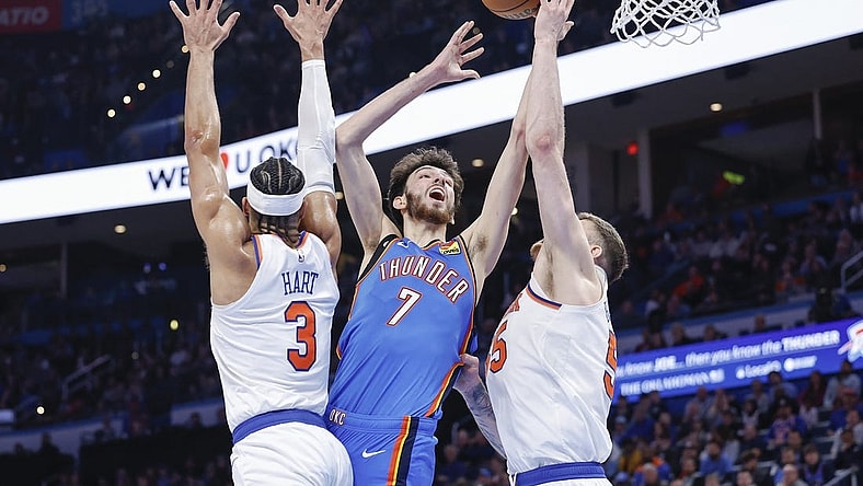Dec 27, 2023; Oklahoma City, Oklahoma, USA; Oklahoma City Thunder forward Chet Holmgren (7) shoots between New York Knicks guard Josh Hart (3) and center Isaiah Hartenstein (55) during the second half at Paycom Center. Mandatory Credit: Alonzo Adams-USA TODAY Sports