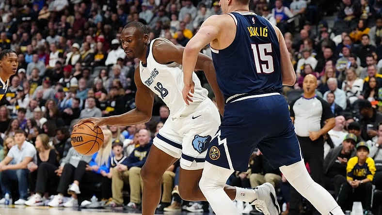Dec 28, 2023; Denver, Colorado, USA; Memphis Grizzlies center Bismack Biyombo (18) drives at Denver Nuggets center Nikola Jokic (15) in the first quarter at Ball Arena. Mandatory Credit: Ron Chenoy-USA TODAY Sports