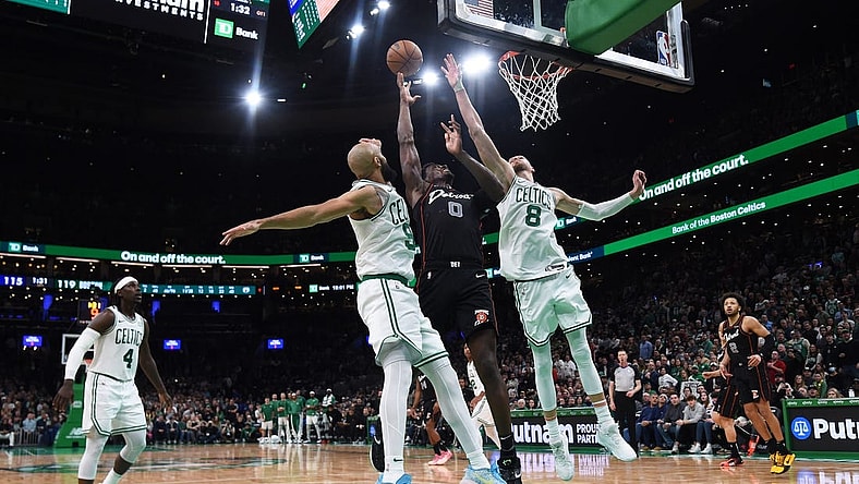 Dec 28, 2023; Boston, Massachusetts, USA;  Boston Celtics guard Derrick White (9) Detroit Pistons center Jalen Duren (0) and center Kristaps Porzingis (8) battle for a rebound during overtime at TD Garden. Mandatory Credit: Bob DeChiara-USA TODAY Sports