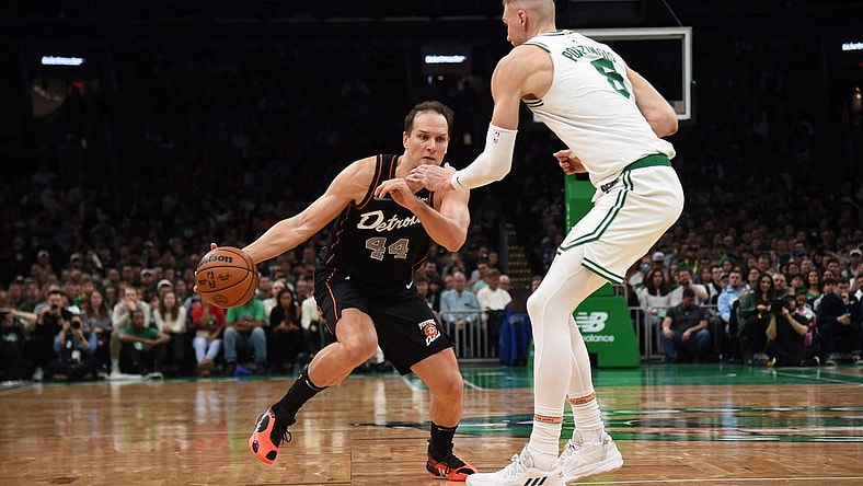 Dec 28, 2023; Boston, Massachusetts, USA;  Detroit Pistons forward Bojan Bogdanovic (44) controls the ball while Boston Celtics center Kristaps Porzingis (8) defends during the second half at TD Garden. Mandatory Credit: Bob DeChiara-USA TODAY Sports