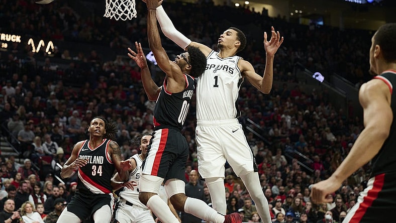 Dec 28, 2023; Portland, Oregon, USA; San Antonio Spurs center Victor Wembanyama (1) blocks a shot during the first half against Portland Trail Blazers guard Scoot Henderson (00) at Moda Center. Mandatory Credit: Troy Wayrynen-USA TODAY Sports