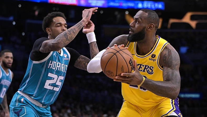 Dec 28, 2023; Los Angeles, California, USA;  Charlotte Hornets forward P.J. Washington (25) defends Los Angeles Lakers forward LeBron James (23) in the first half at Crypto.com Arena. Mandatory Credit: Jayne Kamin-Oncea-USA TODAY Sports