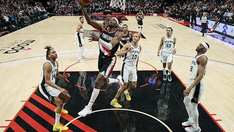 Dec 28, 2023; Portland, Oregon, USA; Portland Trail Blazers forward Jerami Grant (9) scores a basket during the second half against San Antonio Spurs forward Jeremy Sochan (10) at Moda Center. Mandatory Credit: Troy Wayrynen-USA TODAY Sports