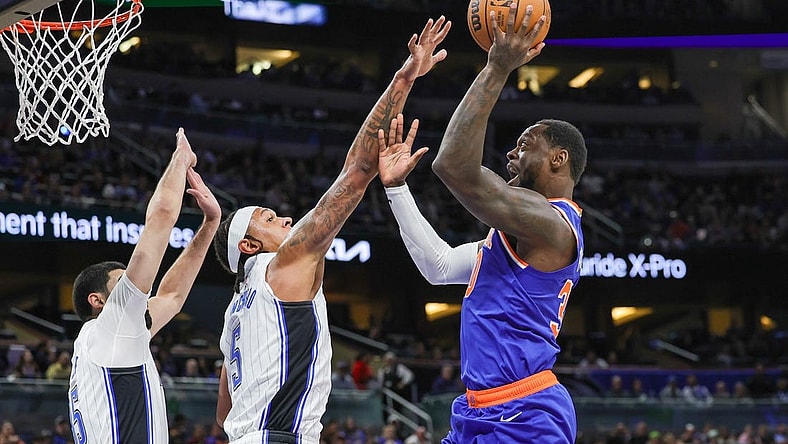 Dec 29, 2023; Orlando, Florida, USA; New York Knicks forward Julius Randle (30) shoots against Orlando Magic forward Paolo Banchero (5) during the first quarter at KIA Center. Mandatory Credit: Mike Watters-USA TODAY Sports