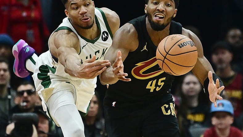 Dec 29, 2023; Cleveland, Ohio, USA; Milwaukee Bucks forward Giannis Antetokounmpo (34) and Cleveland Cavaliers guard Donovan Mitchell (45) go for a loose ball during the first half at Rocket Mortgage FieldHouse. Mandatory Credit: Ken Blaze-USA TODAY Sports