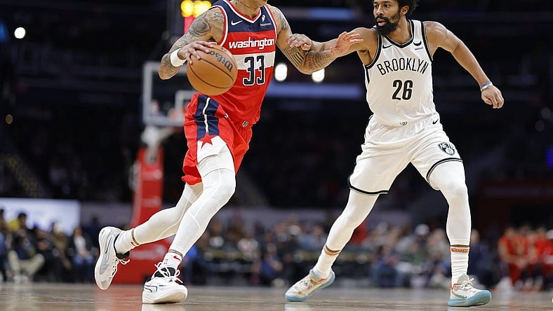 Dec 29, 2023; Washington, District of Columbia, USA; Washington Wizards forward Kyle Kuzma (33) dribbles the ball as Brooklyn Nets guard Spencer Dinwiddie (26) defends in the second quarter at Capital One Arena. Mandatory Credit: Geoff Burke-USA TODAY Sports