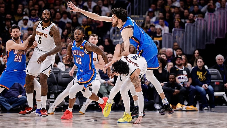 Dec 29, 2023; Denver, Colorado, USA; Oklahoma City Thunder forward Chet Holmgren (7) and Denver Nuggets guard Julian Strawther (3) battle for the ball in the second quarter at Ball Arena. Mandatory Credit: Isaiah J. Downing-USA TODAY Sports