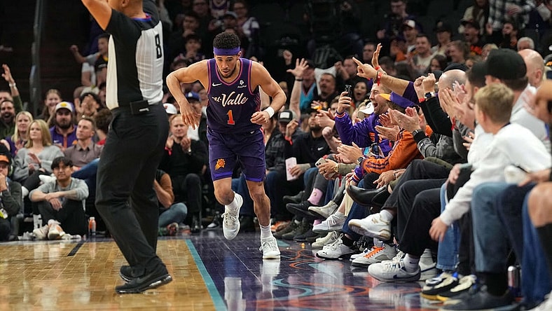 Dec 29, 2023; Phoenix, Arizona, USA; Phoenix Suns guard Devin Booker (1) celebrates a three point basket against the Charlotte Hornets during the first half at Footprint Center. Mandatory Credit: Joe Camporeale-USA TODAY Sports