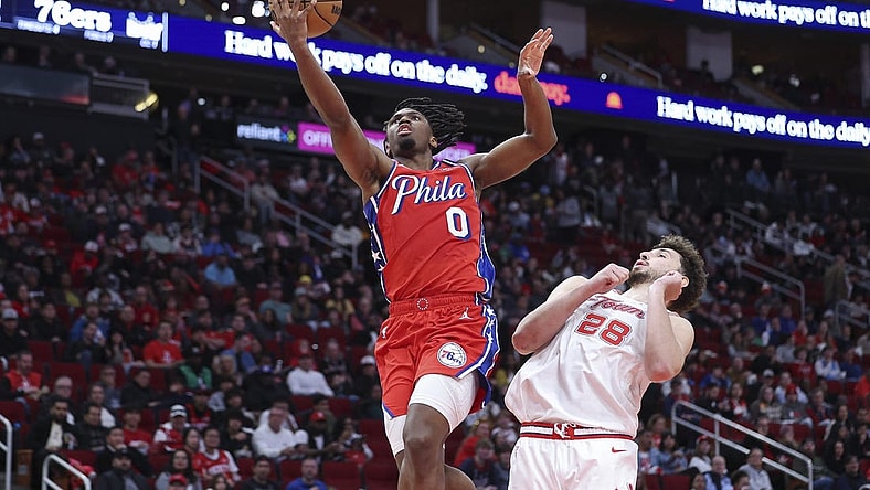 Dec 29, 2023; Houston, Texas, USA; Philadelphia 76ers guard Tyrese Maxey (0) shoots the ball as Houston Rockets center Alperen Sengun (28) defends during the third quarter at Toyota Center. Mandatory Credit: Troy Taormina-USA TODAY Sports