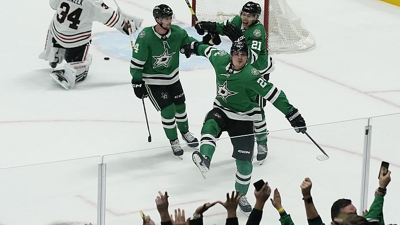 Dec 29, 2023; Dallas, Texas, USA; Dallas Stars center Roope Hintz (24) reacts with defenseman Miro Heiskanen (4) and left wing Jason Robertson (21) in front of Chicago Blackhawks goaltender Petr Mrazek (34) after scoring the game winning goal during overtime at American Airlines Center. Mandatory Credit: Raymond Carlin III-USA TODAY Sports