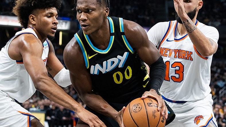 Dec 30, 2023; Indianapolis, Indiana, USA; Indiana Pacers guard Bennedict Mathurin (00) moves to shoot the ball whileNew York Knicks guard Miles McBride (2) and guard Evan Fournier (13)  defend in the second quarter at Gainbridge Fieldhouse. Mandatory Credit: Trevor Ruszkowski-USA TODAY Sports