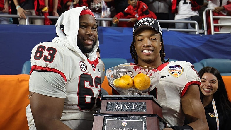Dec 30, 2023; Miami Gardens, FL, USA; Georgia Bulldogs running back Kendall Milton (2) holds the MVP game trophy with offensive lineman Sedrick Van Pran (63)after the Capital One Orange Bowl at Hard Rock Stadium. Mandatory Credit: Nathan Ray Seebeck-USA TODAY Sports