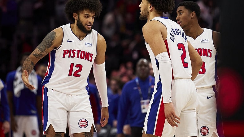 Dec 30, 2023; Detroit, Michigan, USA;  Detroit Pistons forward Isaiah Livers (12) and guard Cade Cunningham (2) celebrate after the game against the Toronto Raptors at Little Caesars Arena. Mandatory Credit: Rick Osentoski-USA TODAY Sports