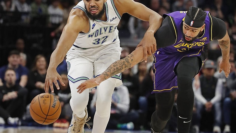 Dec 30, 2023; Minneapolis, Minnesota, USA; Los Angeles Lakers forward Anthony Davis (3) knocks the ball away from Minnesota Timberwolves forward Karl-Anthony Towns (32) in the first quarter at Target Center. Mandatory Credit: Bruce Kluckhohn-USA TODAY Sports