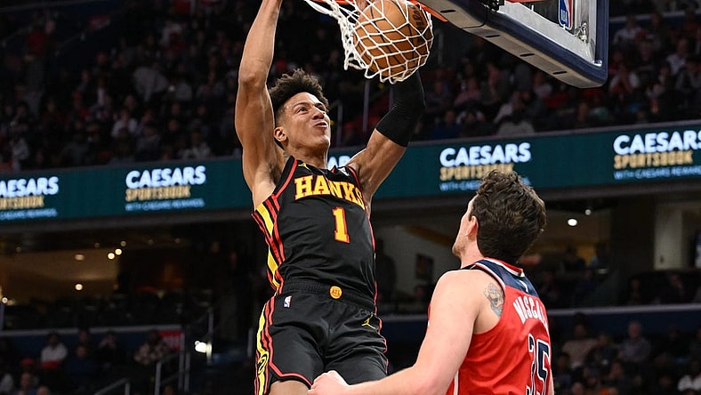 Dec 31, 2023; Washington, District of Columbia, USA;  Atlanta Hawks forward Jalen Johnson (1) dunks the ball as Washington Wizards center Mike Muscala (35) looks on during the first half at Capital One Arena. Mandatory Credit: James A. Pittman-USA TODAY Sports
