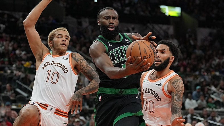 Dec 31, 2023; San Antonio, Texas, USA;  Boston Celtics guard Jaylen Brown (7) loses the ball in front of San Antonio Spurs forwards Jeremy Sochan (10) Julian Champagnie (30) in the first half at Frost Bank Center. Mandatory Credit: Daniel Dunn-USA TODAY Sports