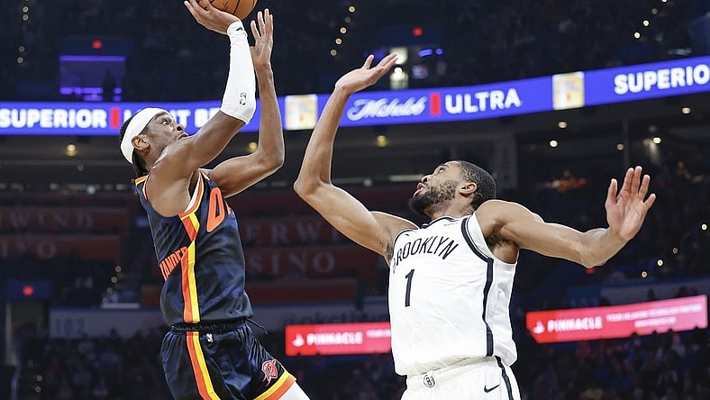 Dec 31, 2023; Oklahoma City, Oklahoma, USA; Oklahoma City Thunder guard Shai Gilgeous-Alexander (2) shoots as Brooklyn Nets forward Mikal Bridges (1) defends during the second quarter at Paycom Center. Mandatory Credit: Alonzo Adams-USA TODAY Sports
