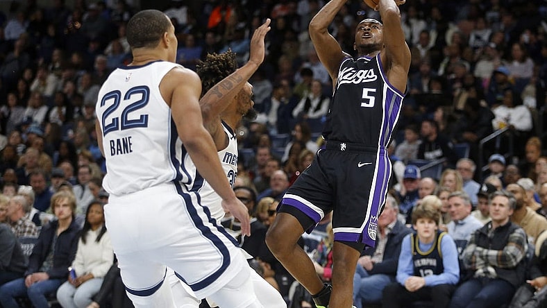 Dec 31, 2023; Memphis, Tennessee, USA; Sacramento Kings guard De'Aaron Fox (5) shoots as Memphis Grizzlies guard Marcus Smart (36) defends during the first half at FedExForum. Mandatory Credit: Petre Thomas-USA TODAY Sports
