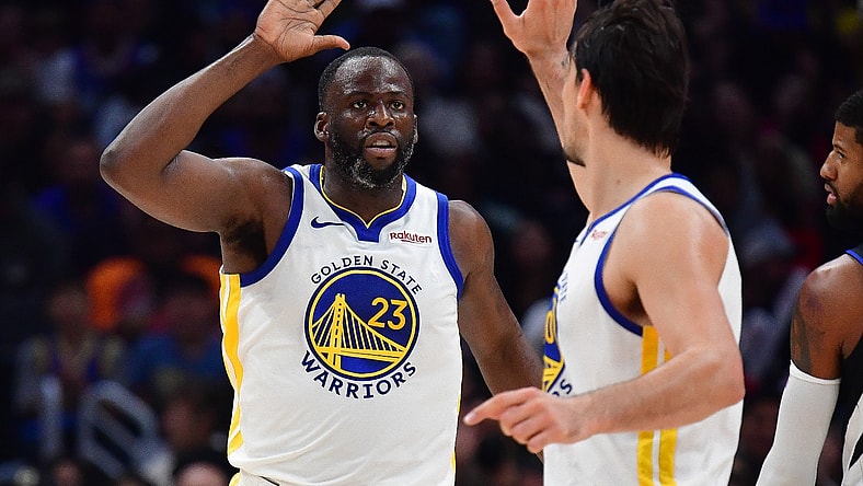 Draymond Green: Warriors Draymond Green high fives with teammate Dario Saric