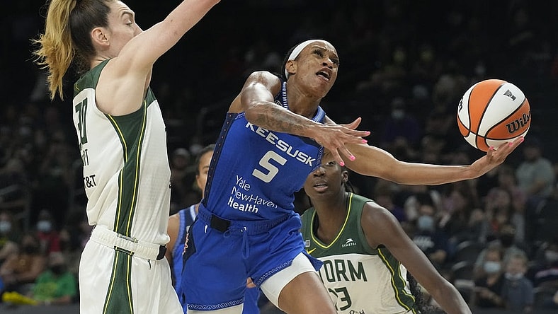 Aug 12, 2021; Phoenix, Arizona, USA; Connecticut Sun guard Jasmine Thomas (5) drives against Seattle Storm forward Breanna Stewart (30) in the second half during the Inaugural WNBA Commissioners Cup Championship Game at Footprint Center. Mandatory Credit: Rick Scuteri-USA TODAY Sports