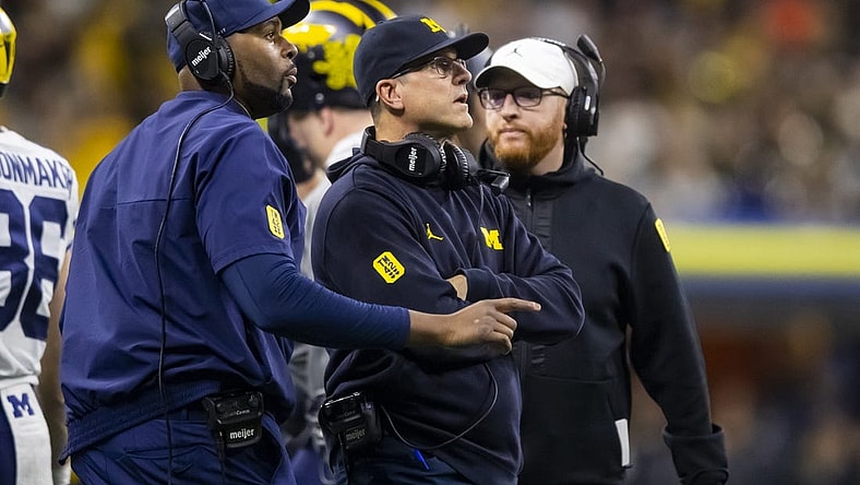 Dec 4, 2021; Indianapolis, IN, USA; Michigan Wolverines offensive line coach Sherrone Moore (left), head coach Jim Harbaugh (center) and special teams coordinator Jay Harbaugh against the Iowa Hawkeyes in the Big Ten Conference championship game at Lucas Oil Stadium. Mandatory Credit: Mark J. Rebilas-USA TODAY Sports