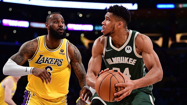 Feb 8, 2022; Los Angeles, California, USA; Milwaukee Bucks forward Giannis Antetokounmpo (34) moves the ball against Los Angeles Lakers forward LeBron James (6) during the second half at Crypto.com Arena. Mandatory Credit: Gary A. Vasquez-USA TODAY Sports