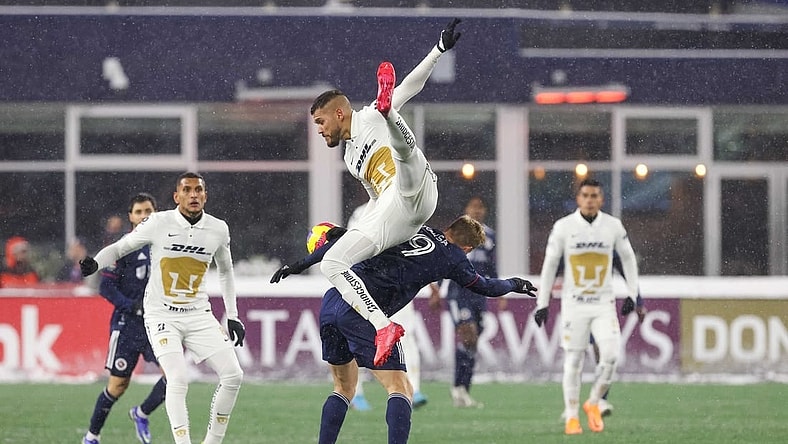Mar 9, 2022; Foxborough, Massachusetts, USA; Pumas UNAM defender Nicolas Freire (23) heads the ball over New England Revolution forward Adam Buksa (9) during the second half at Gillette Stadium during the 2022 CONCACAF Champions League Quarterfinals. Mandatory Credit: Paul Rutherford-USA TODAY Sports