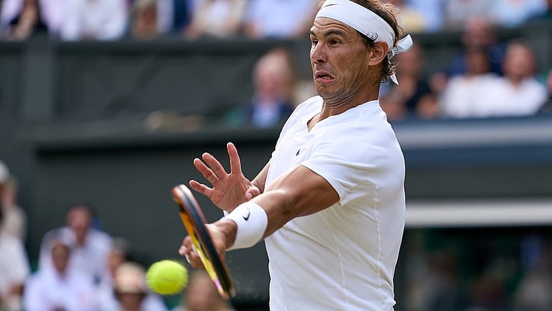 Jul 6, 2022; London, England, United Kingdom; Rafael Nadal (ESP) returns a shot during his quarter finals men s singles match against Taylor Fritz (USA) on Centre court at All England Lawn Tennis and Croquet Club. Mandatory Credit: Peter van den Berg-USA TODAY Sports