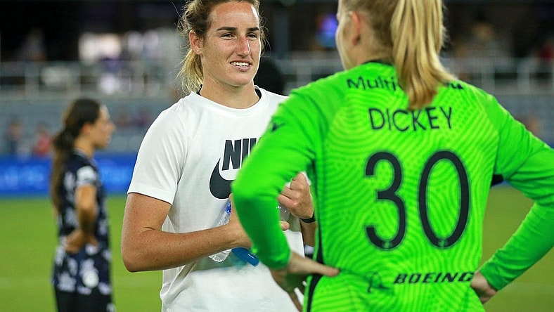 Aug 2, 2022; Louisville, Kentucky, USA; Racing Louisville FC goalkeeper Hillary Beall (left) talks with OL Reign goalkeeper Claudia Dickey (30) after the game at Lynn Family Stadium. Mandatory Credit: EM Dash-USA TODAY Sports